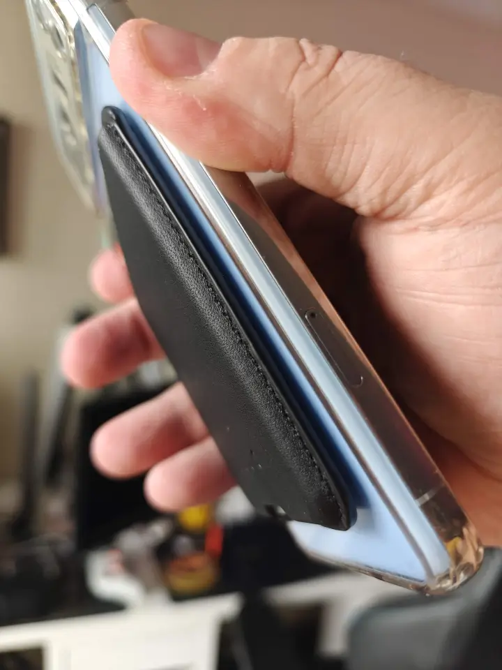 Mujjo Leather Magnetic Wallet firmly attached to the Pixel 8 Pro, demonstrating the strong magnetic grip and secure attachment.